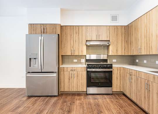A modern kitchen with wooden cabinets and stainless steel appliances.