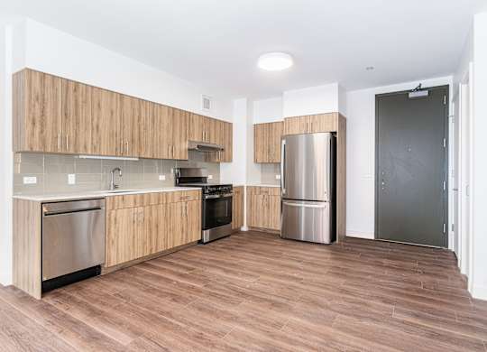 A kitchen with wooden cabinets and stainless steel appliances.