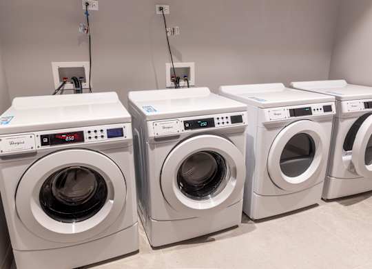 Shared laundry room with front load washers at Thrive Exchange Apartments, Chicago, Illinois
