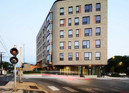 Modern apartment building at street corner intersection at Thrive Exchange Apartments, Chicago, Illinois
