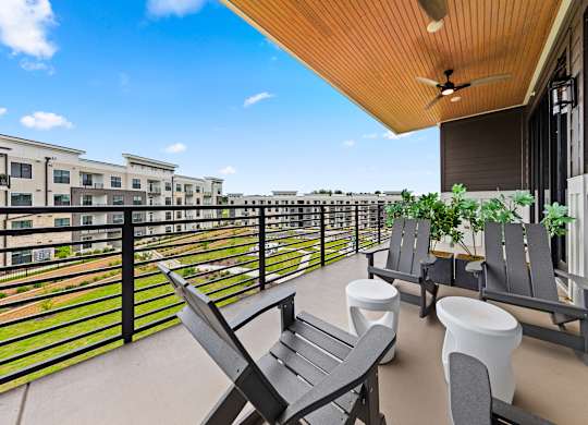 Balcony with chairs and table at Views at Flowers, North Carolina, 27527