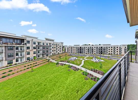 View of green lawn from a balcony at Views at Flowers, North Carolina, 27527