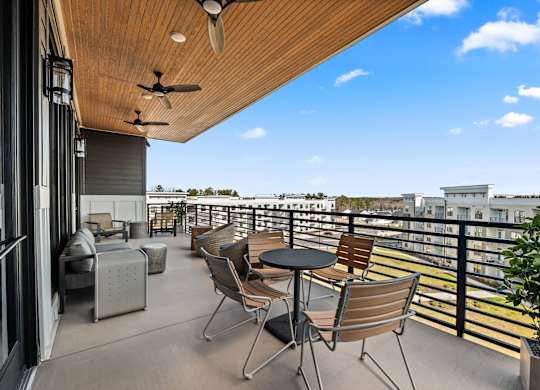 Balcony with tables and chairs at Views at Flowers, Clayton, NC