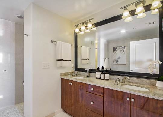 A bathroom with a large mirror and a sink.