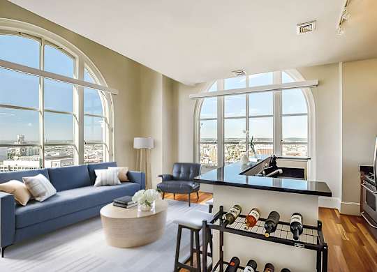 A modern kitchen with a large window overlooking the city.