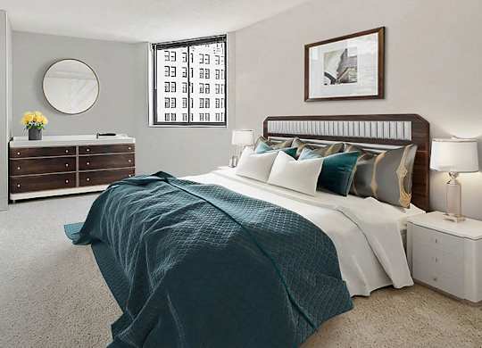 A bedroom with a bed, nightstand, and a dresser with a mirror.
