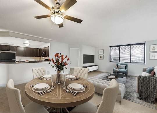 A modern dining room with a round table set for six.