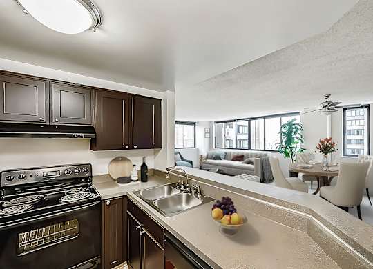 A modern kitchen counter looking into living room
