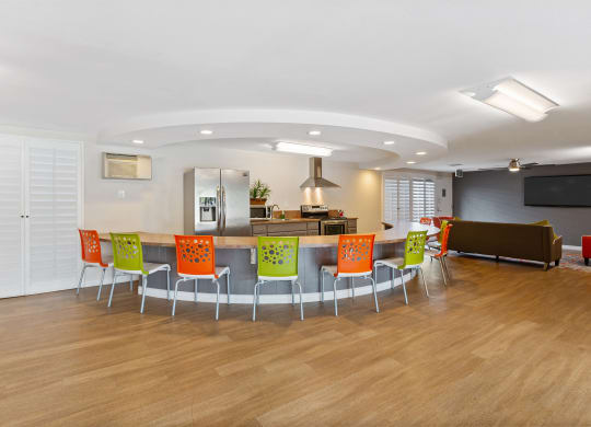 a conference room with a table and chairs and a kitchen at Terramonte Apartment Homes, Pomona, CA