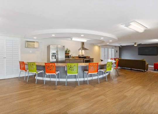 a conference room with a table and chairs and a kitchen at Terramonte Apartment Homes, Pomona, CA