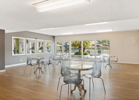 the preserve at ballantyne commons community room with tables and chairs and windows at Terramonte Apartment Homes, Pomona