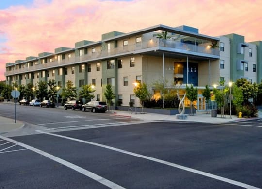a large apartment building with a parking lot in front of it at Helix at University Village, California