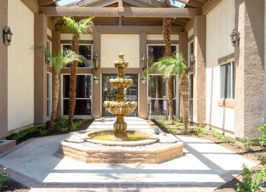 a fountain in front of a building at Oak Terrace Senior Apts, Hemet, 92543