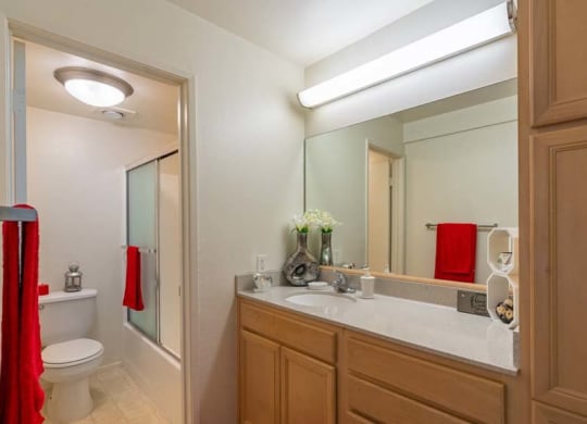 a bathroom with a toilet a sink and a mirror at Mountainview Venture, Covina California