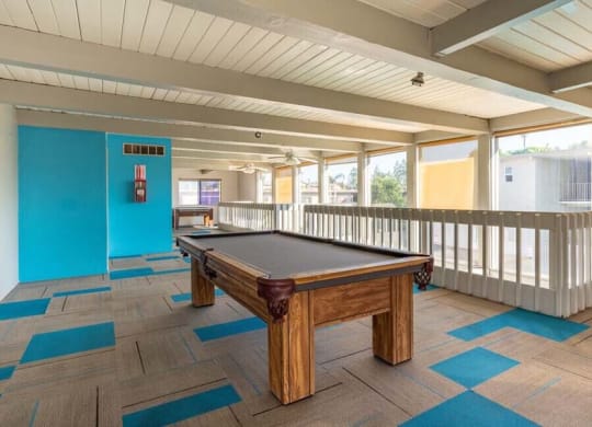 a pool table sitting on top of a wooden table at Mountainview Venture, Covina