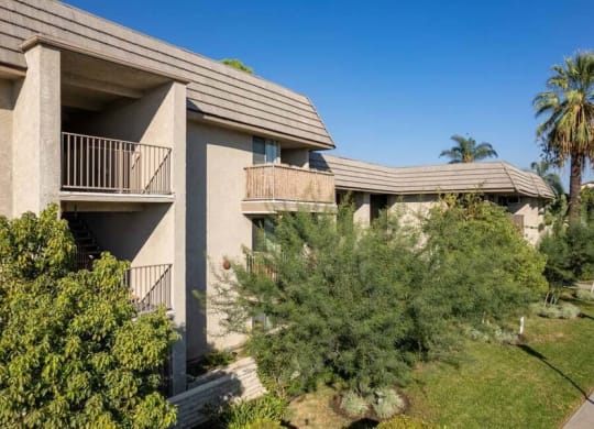 a building with two balconies and trees in front of it at Mountainview Venture, Covina, 91722