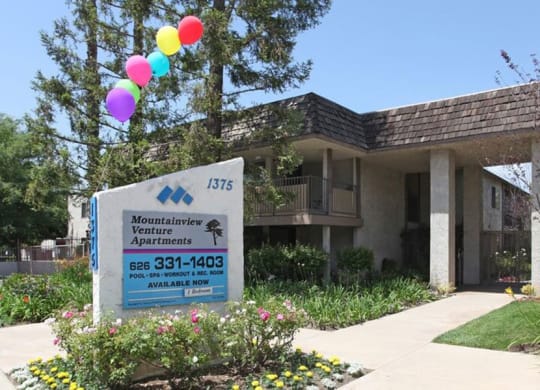 a building with a sign and balloons in front of it at Mountainview Venture, Covina, CA