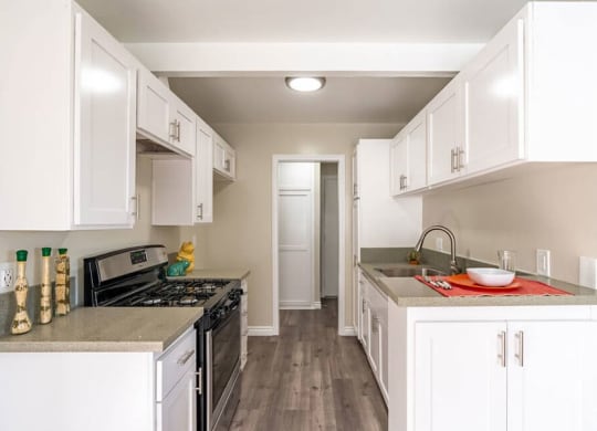 a kitchen with white cabinets and a black stove top oven at Mountainview Venture, California, 91722