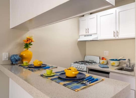 a kitchen with a stove top oven next to a sink at Mountainview Venture, Covina, 91722