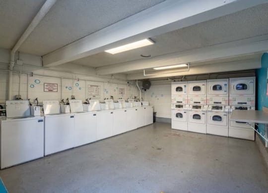 a room filled with lots of white washers and dryers at Mountainview Venture, California, 91722