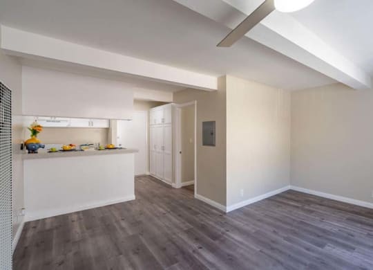 a kitchen and living room with hardwood floors and a ceiling fan at Mountainview Venture, California