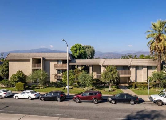 an apartment complex with cars parked in front of it at Mountainview Venture, Covina, CA 91722