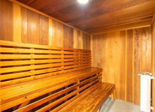 a sauna with a wooden bench and a trash can at Mountainview Venture, Covina California