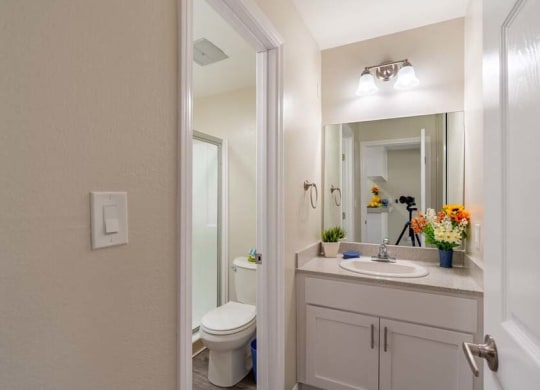a bathroom with a toilet sink and mirror at Mountainview Venture, Covina California