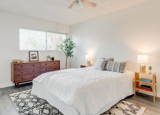 a bedroom with a white bed and a dresser at University Park, Azusa, 91702