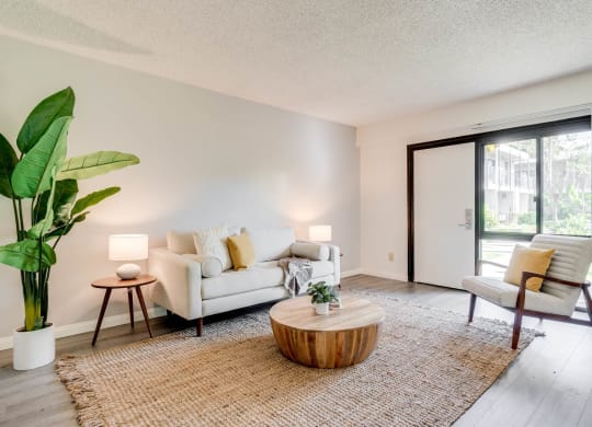 a living room with a couch and a coffee table and a sliding glass door at University Park, California, 91702
