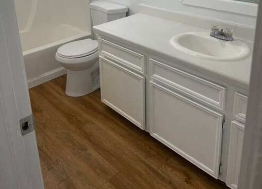 a bathroom with a toilet sink and bathtub  at Fiesta Apts, California
