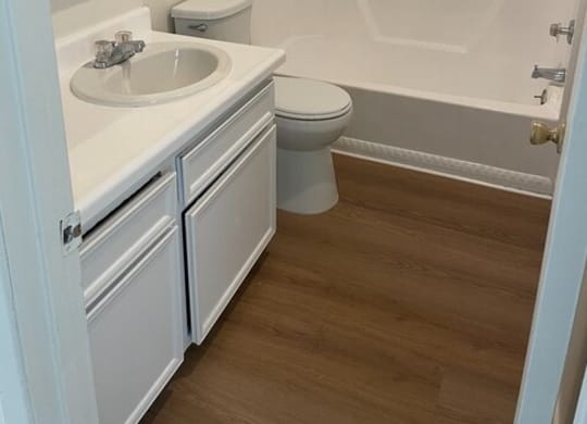 a bathroom with a toilet sink and bathtub at Fiesta Apts, Lompoc, CA