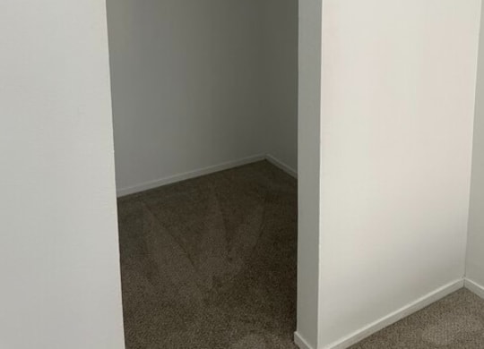 a walk in closet in a bedroom at Fiesta Apts, California