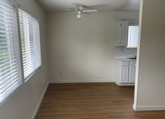 an empty living room with a ceiling fanat Fiesta Apts, Lompoc, CA