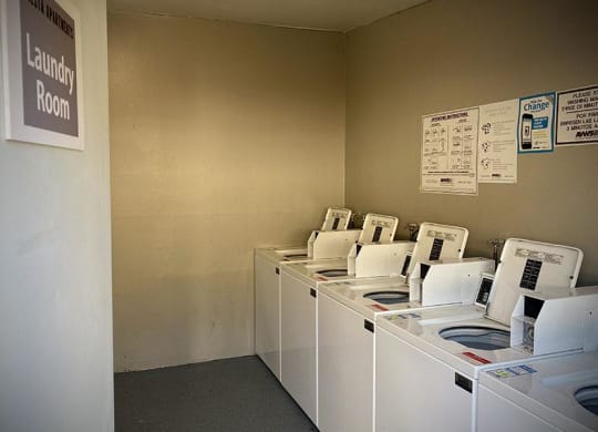 a row of washing machines sitting next to each other at Fiesta Apts, Lompoc