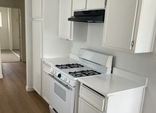 a kitchen with a stove and a refrigerator at Fiesta Apts, California, 93436