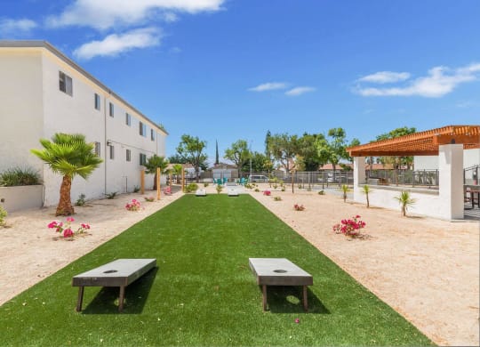 a garden outside a building with grass and benches at Sunnymead Apts Apartments, Moreno Valley, CA