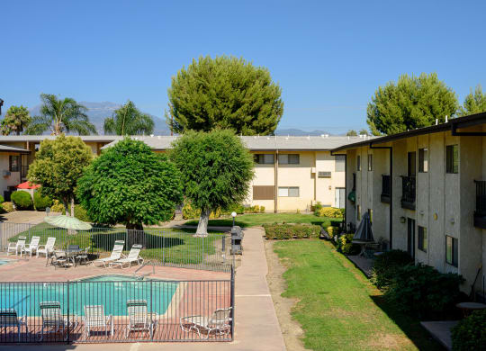 a view of the courtyard and pool at the whispering winds apartments in pearland, tx at Park Columbia Apts, Hemet, CA