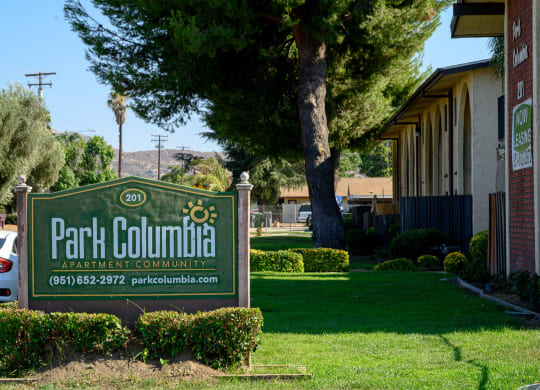 a sign in front of a building at Park Columbia Apts, California, 92544