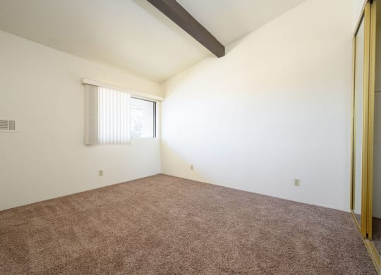 a bedroom with white walls and carpet at Park Columbia Apts, Hemet, 92544