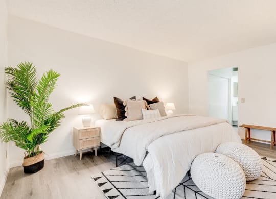 a bedroom with a bed and a potted plant at Alosta Place, Azusa, CA