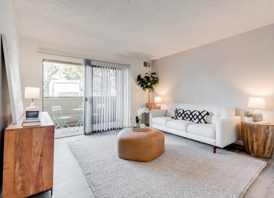 a living room with a couch and a coffee table and a sliding glass door at Alosta Place, California, 91702