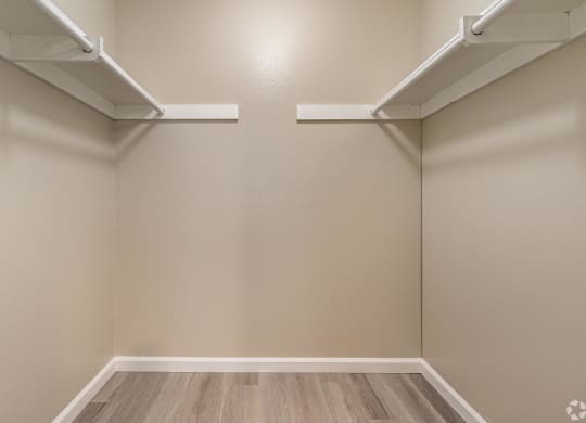 an empty room with white shelves on the wall and wood floors at Colima Terrace Apts, Rowland Heights, CA 91748