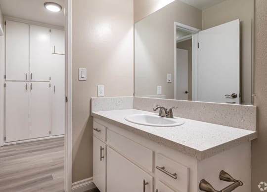 an empty bathroom with a sink and a mirror at Colima Terrace Apts, Rowland Heights California
