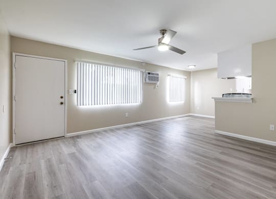 an empty living room with wood floors and a ceiling fan at Colima Terrace Apts, Rowland Heights