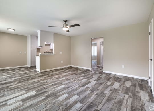 an empty living room with vinyl flooring and a ceiling fan at Colima Terrace Apts, Rowland Heights California