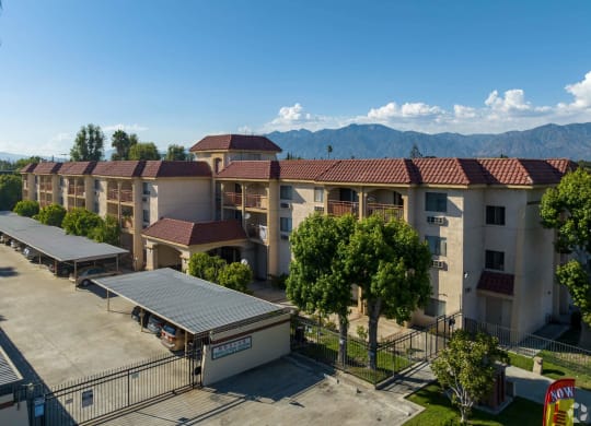 an aerial view of an apartment complex with mountains in the background   at Flamingo Garden Senior Apts, El Monte, CA 91732