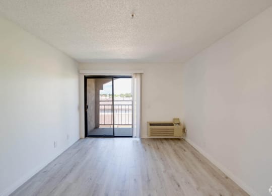 the preserve at ballantyne commons apartment living room with wood flooring and balcony at Flamingo Garden Senior Apts, El Monte