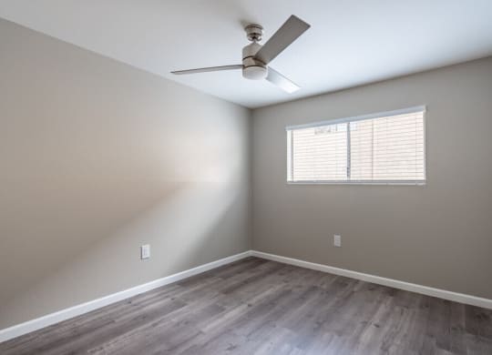 an empty room with a ceiling fan and a window at North View Terrace, California