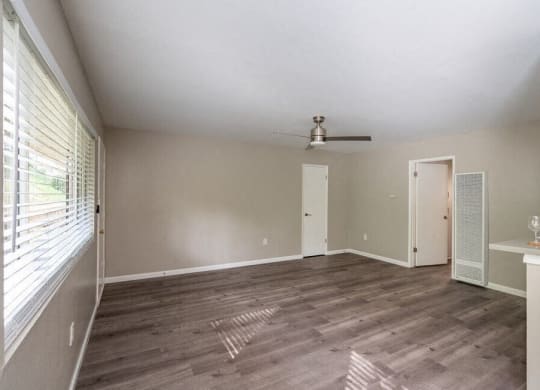 an empty living room with a ceiling fan and a window at North View Terrace, California